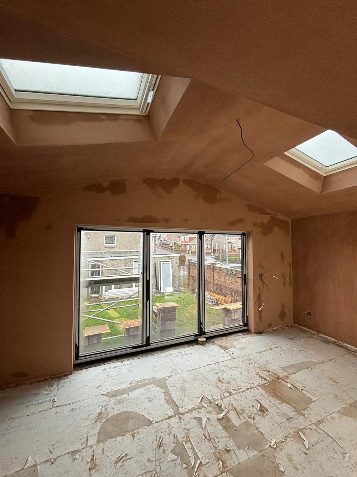 Freshly plastered room with skylights and bifold doors