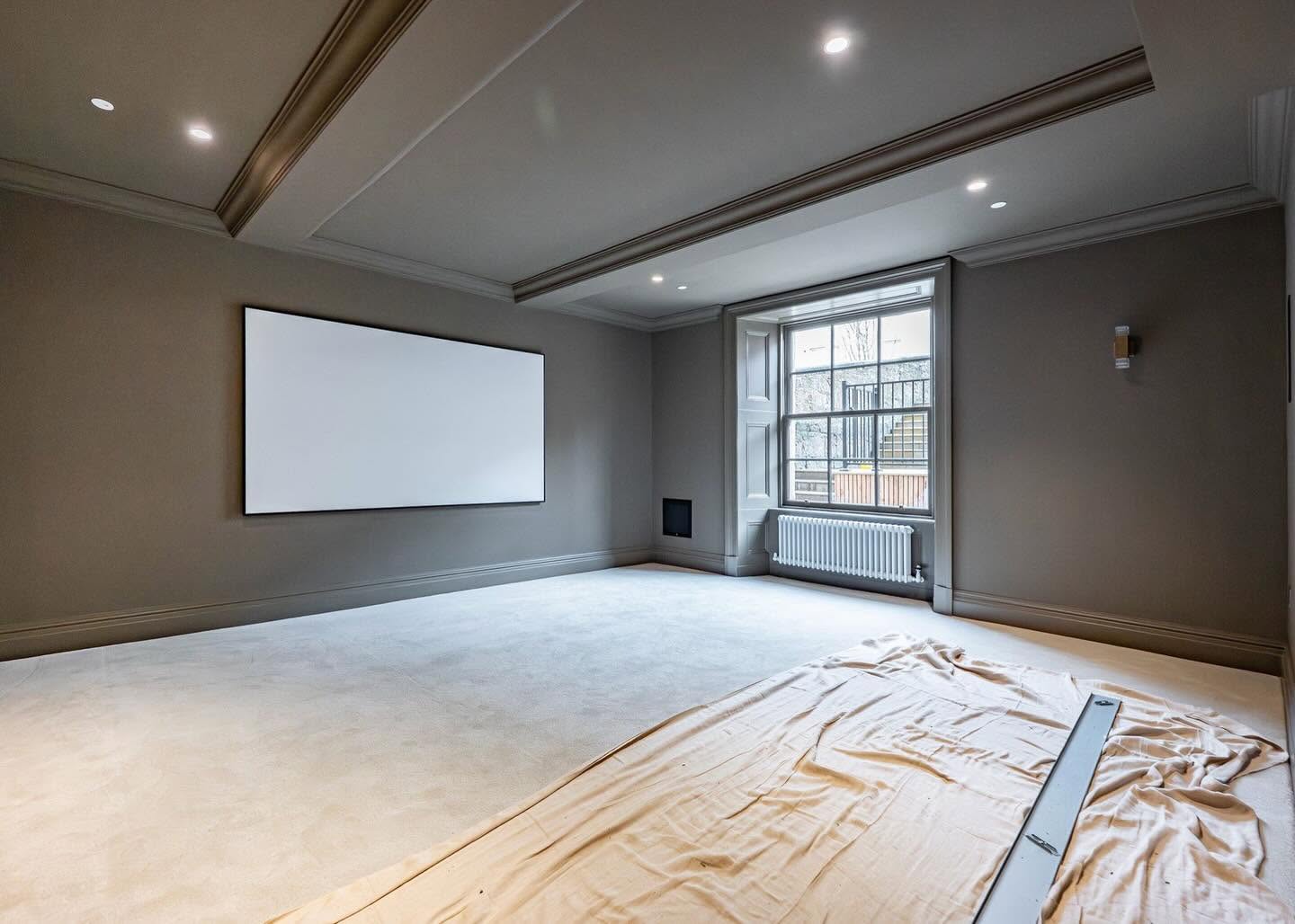 Media room with smooth walls, ceiling and coving