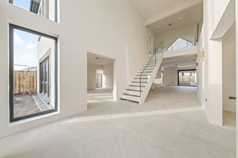 Double-height open-plan space finished smooth throughout